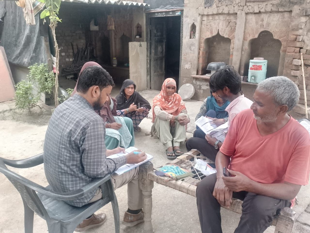 A BKIF team member conducts a survey with villagers