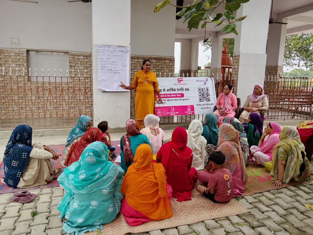 A BKIF trainer leads a session with women in a village courtyard